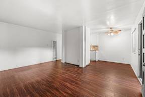 A room with wooden floors and white walls.