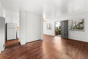 A room with wooden floors and white walls.