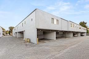 A large concrete building with multiple garage doors.