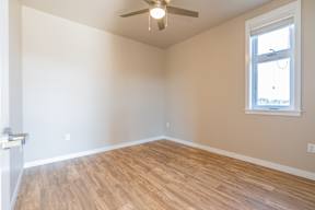 A room with a ceiling fan and a window.