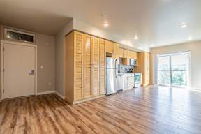 A kitchen with wooden cabinets and a white fridge.