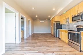A kitchen with wooden cabinets and a white door.
