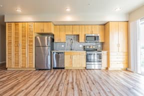 A kitchen with wooden cabinets and stainless steel appliances.