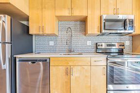 A kitchen with wooden cabinets and stainless steel appliances.