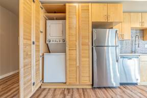 A kitchen with a refrigerator and a sink.