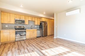 A kitchen with wooden cabinets and a refrigerator.