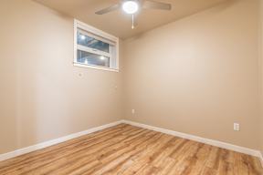 A room with a ceiling fan and a window.