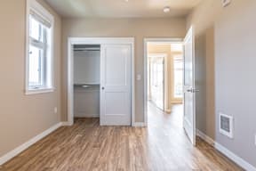 A kitchen area with a white door and a window.