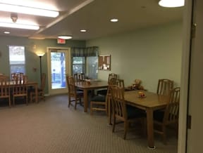 A dining room with a table set for six people.