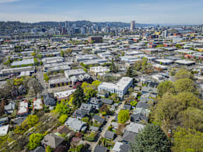 A cityscape with a mix of residential and commercial buildings.