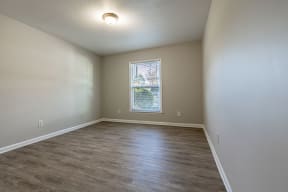 an empty living room with wood flooring and a window at Sharon West, Charlotte, NC
