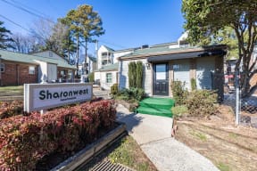 a house with a sidewalk and a sign in front of it at Sharon West, Charlotte