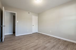 an empty living room with wood flooring and white walls at Sharon West, Charlotte, NC 28210