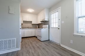 an empty kitchen with white appliances and white cabinets at Sharon West, North Carolina