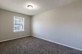 an empty room with carpet and a window at Sharon West, Charlotte, NC 28210