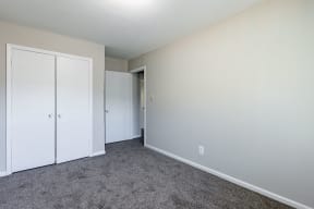a bedroom with carpet and white doors at Sharon West, Charlotte, NC