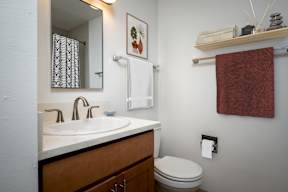 A bathroom with a toilet, sink, and towel rack at Timberlee, Portland, Oregon