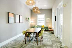 A dining room with a round table and chairs.