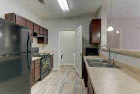the heights at converse apartments inside of the kitchen with refrigerator and sink and cabinets