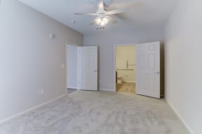 the heights at converse apartments inside bedroom with lighted ceiling fan and light paint