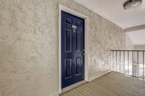 a blue front door to an apartment home at Veridian at Sandy Springs