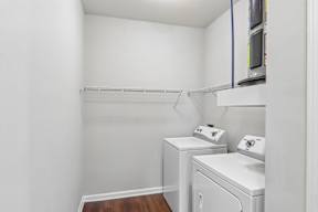A small laundry room with a washer and dryer.