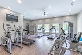 A spacious gym with a variety of exercise equipment.