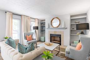A living room with a fireplace and a white couch.