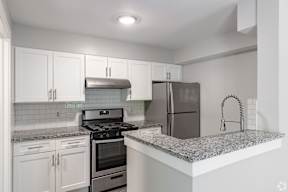 A kitchen with a stove, oven, and refrigerator.