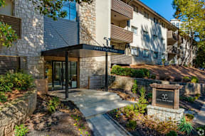 A modern building with a stone facade and a sign that reads "FIVE PHASES".