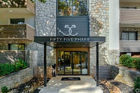 The entrance to a building with a sign that reads "FIFTY FIVE PHARR".