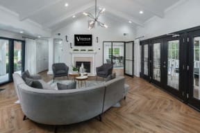 Veridian at Sandy Springs apartments clubhouse interior filled with furniture and a fire place