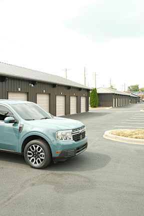 a blue car parked in front of a building