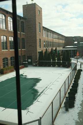 a view of a tennis court in the snow from a building