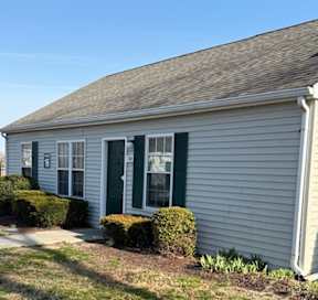 A small house with a green door and windows.