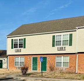 A building with a blue sign in front of it.