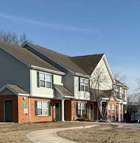 A row of houses with a clear blue sky above them.