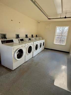 A row of washing machines in a laundromat.