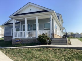 a house with a for sale sign in front of it