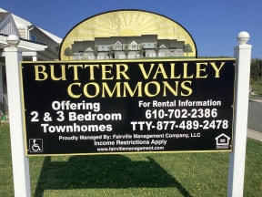 a sign in front of a house that says butter valley commons