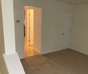 an empty room with a door open