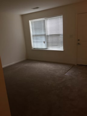 an empty room with a window and a door