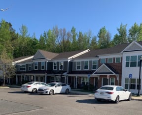 a large building with a parking lot in front of it