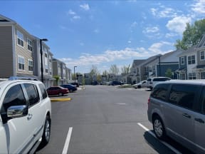 a parking lot in front of a row of houses