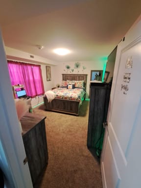 a bedroom with a bed and a desk