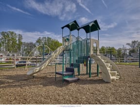 a playground with a slide and climbing equipment