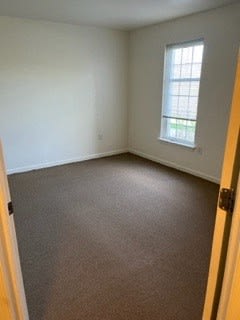 an empty room with a window and a door