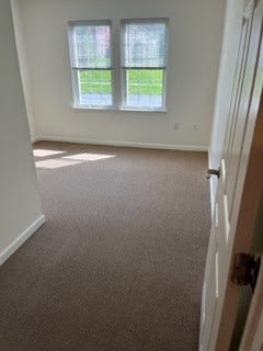 a room with a door and two windows