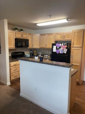 a kitchen with a counter top and a refrigerator