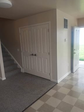 a picture of a hallway with two doors and a checkered floor